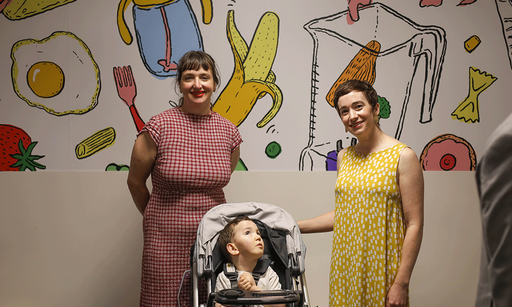 Billie Justice Thomson, Miles McGuiness and Clare McGuiness in front of the Love Feeds Everybody mural.